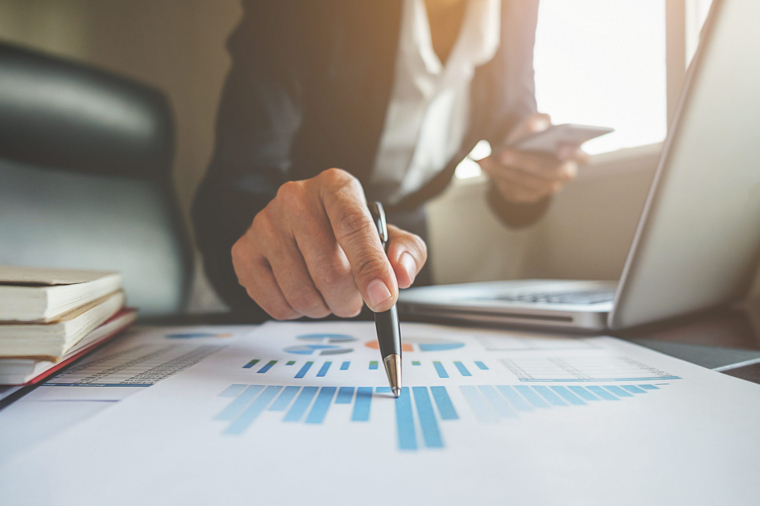 Dirigeant analysant des données financières lors d’un investissement et d’une acquisition stratégique dans le secteur télécom, illustrant la reprise d’entreprise par Winvest Capital, opérateur téléphonique et investisseur.